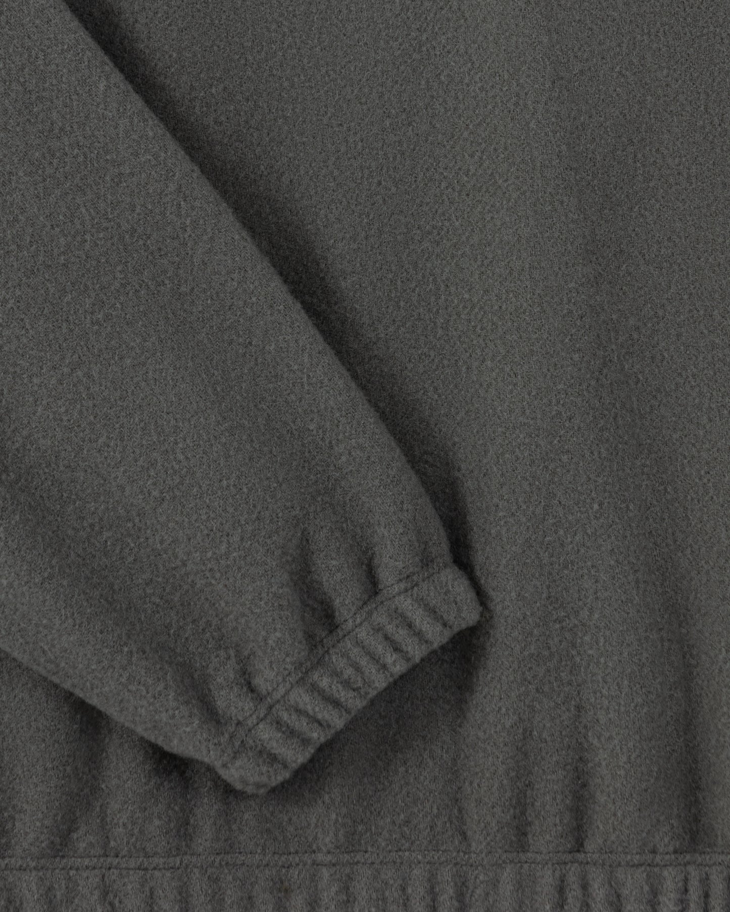 RIER half zip wool fleece in Zinc grey, close-up of the elasticated cuff and natural wool fleece texture