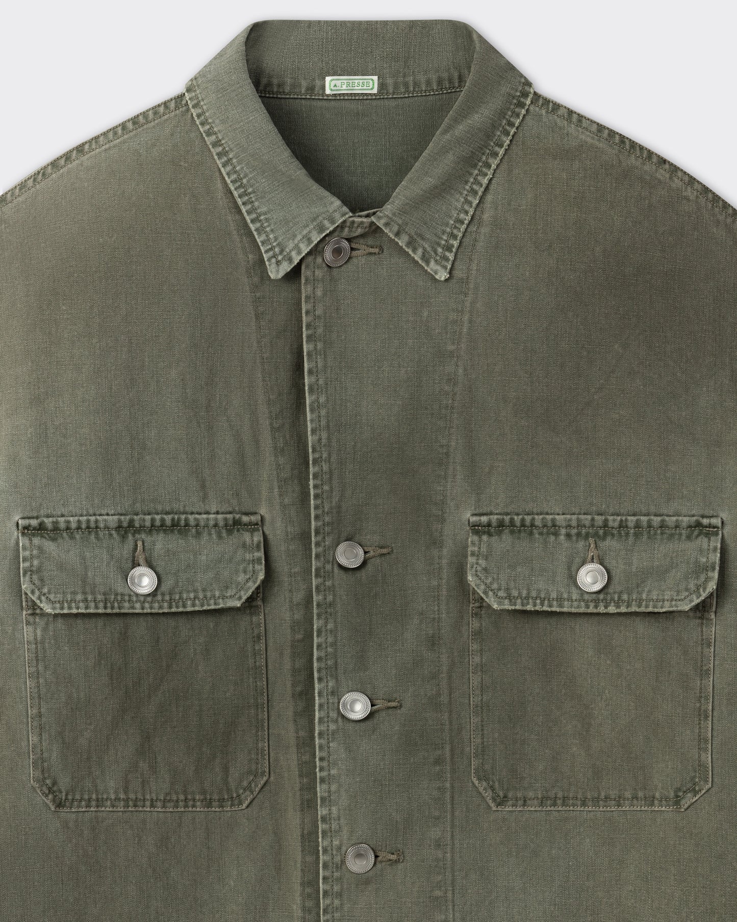 A.PRESSE M-42 jacket in sage cotton herringbone twill, close-up on the fabric and buttons