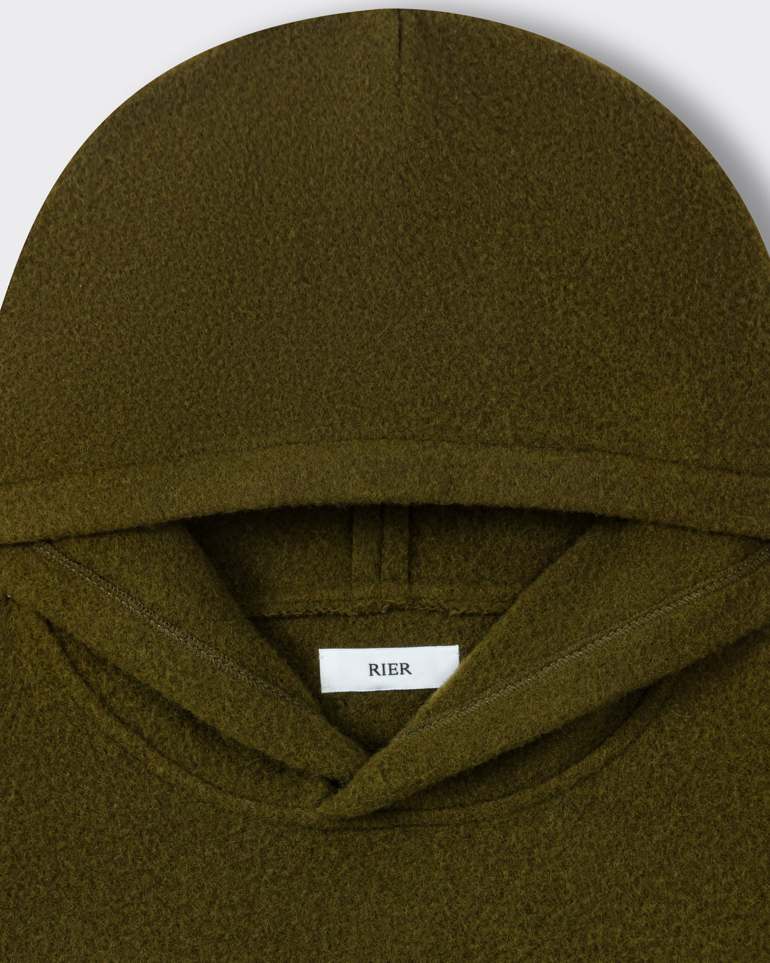 RIER hooded wool fleece in Soil olive green, close-up of the hood and woven label