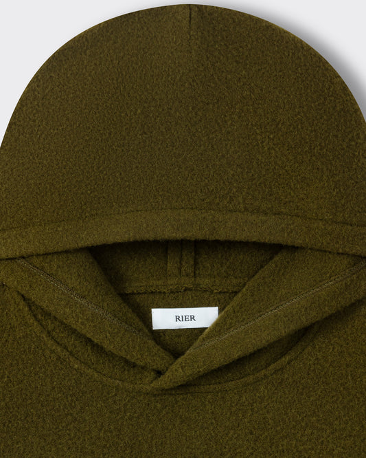RIER hooded wool fleece in Soil olive green, close-up of the hood and woven label