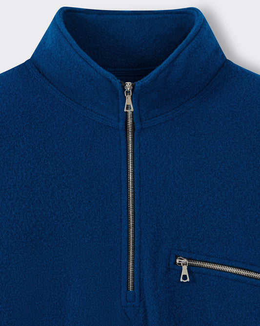 RIER half zip wool fleece in indigo blue, close-up of the Riri metal zip and zipped chest pocket