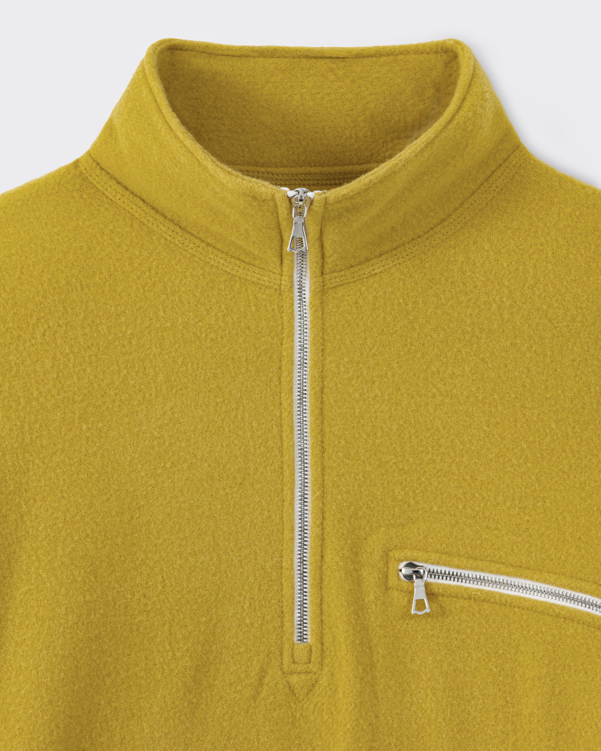 RIER half zip wool fleece in Wax mustard yellow, close-up of the Riri metal zip and zipped chest pocket