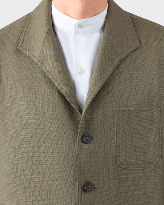 Lapel and horn button detail — olive Teba Jacket